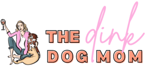 Logo which shows a drawing of a blonde woman sitting with crossed legs holding a glass of wine. Two dogs sit next to her: June, a blonde mutt with pointed ears, and Margot, a red and white australian shepherd. Next to the drawing it says "the DINK dog mom"