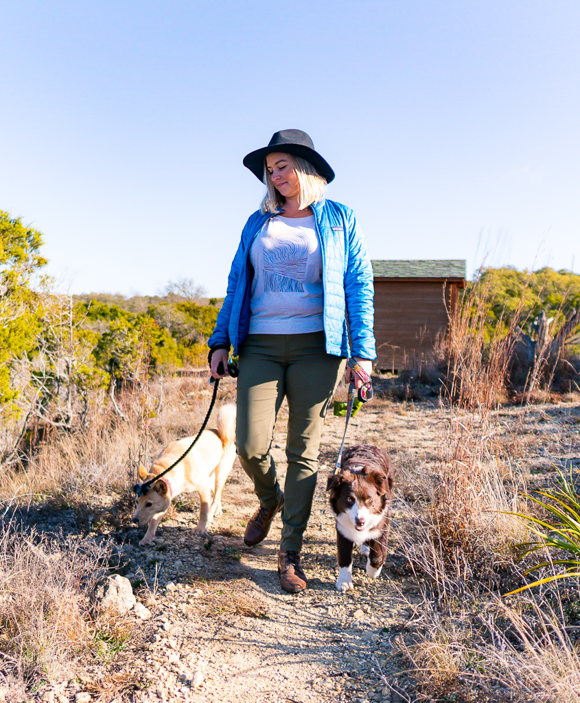 girl walking two dogs