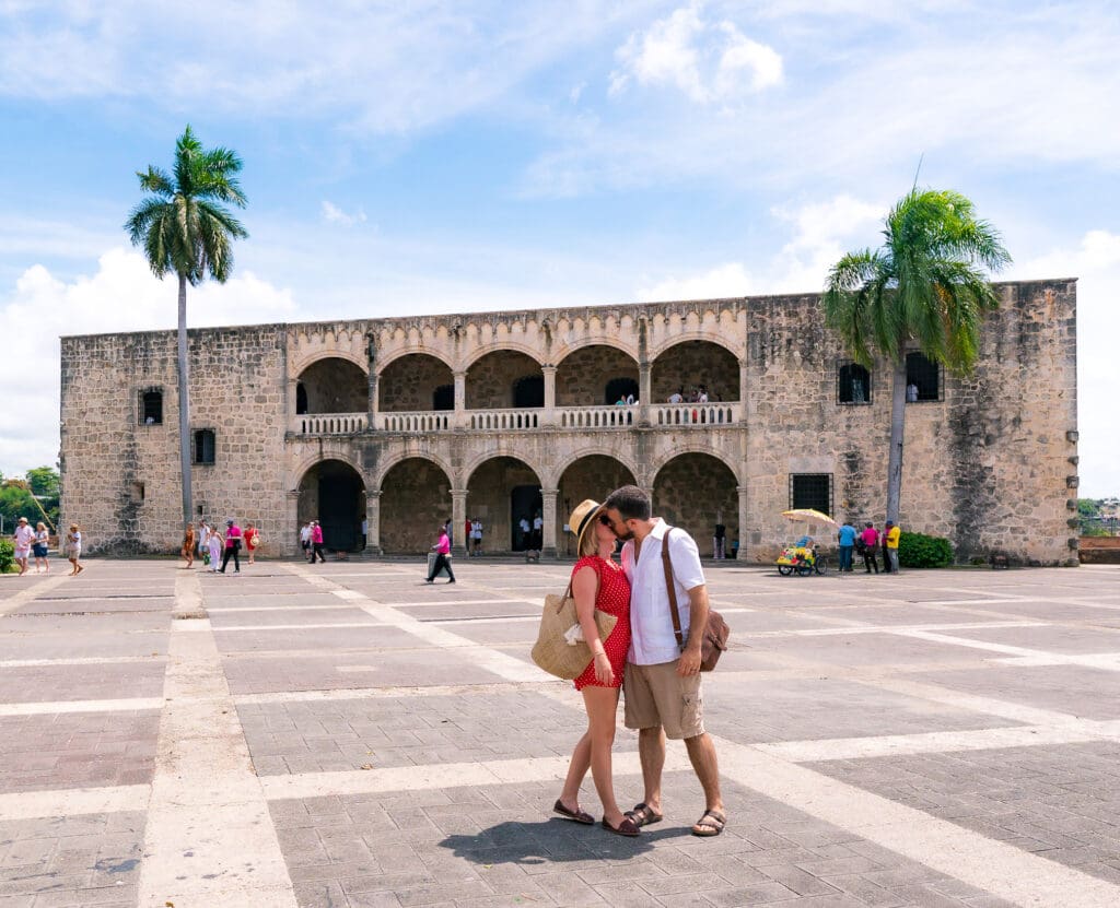 Childfree couple kissing in front of an old building in the Dominican Republic