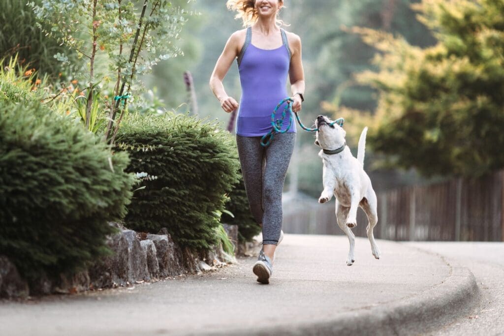 woman jogs with her dog